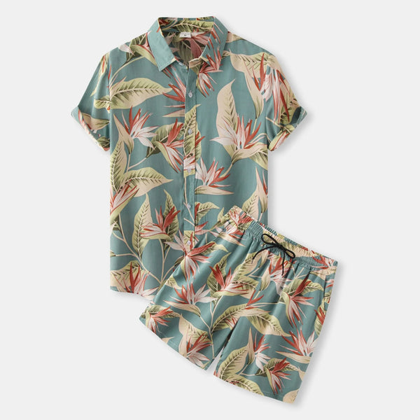 Front flat lay of Velnox Riviera Shorts Set in Air Force Blue tropical floral print with collared button-up shirt and drawstring shorts