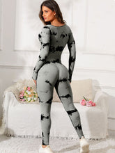 Back view of gray Prism Flow jumpsuit showing long sleeves and fitted silhouette.