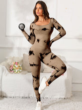 Female doing aerobics in taupe PrismFlow jumpsuit with trainers in gym