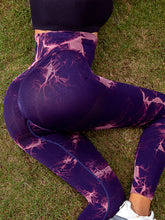 back angle laying on grass wearing veloraform leggings purple