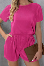 Model styling Velviluxe™ hot pink shorts set with sneakers and hoops for a casual brunch look.