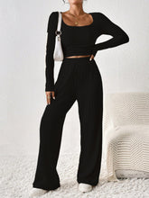 Verdelle Scoop Wide Leg Lounge Duo in black styled with sneakers and accessories