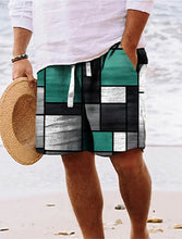 Man walking on beach wearing emerald green geometric color block shorts.