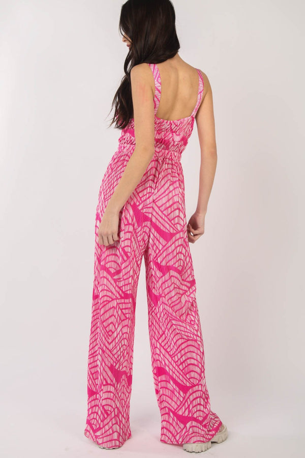 Rear view of the model revealing the full back design and continuation of the print with elegant pleats.