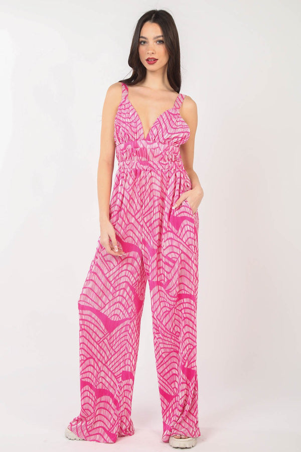 Model wearing the VERY J Printed Pleated Sleeveless Wide Leg Jumpsuit, highlighting the bold print and flattering pleated silhouette.