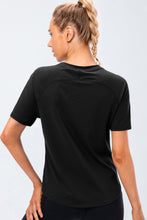 Verzana Active Tee in black — back view, soft performance fabric.