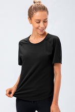 Close-up of black Verzana Active Tee neckline and stretch fabric.