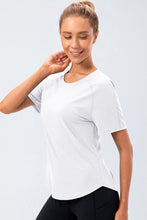 White Verzana Active Tee worn in active movement, moisture-wicking stretch fabric.