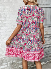 Back view of Vesaluna Paisley Print Tie Neck Dress in pink, showcasing short sleeves and flattering A-line silhouette.