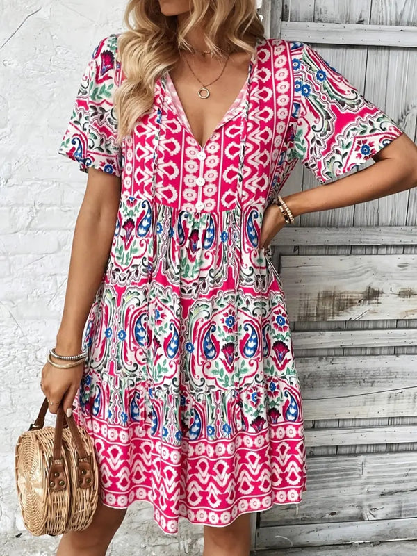 Front view of Vesaluna Paisley Print Tie Neck Dress in pink, featuring soft paisley print and adjustable tie-neck detail.