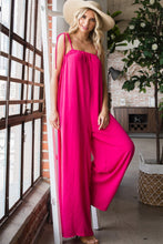 Close-up of the top half of a Fuchsia Veveret Pocketed Spaghetti Strap Wide Leg Jumpsuit highlighting its pocket and strap details.