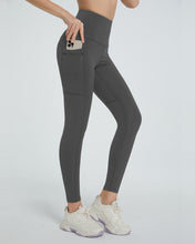 side view showing stretch fabric of virexaform sculpt leggings dark gray with phone in side pocket