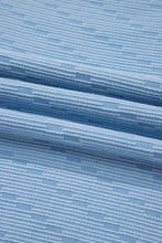 Zoomed-in view of Vivenza Luxe™ knit fabric texture and bold contrast trim details.