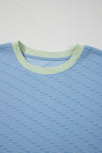 Knit texture and contrast neckline detail close-up.