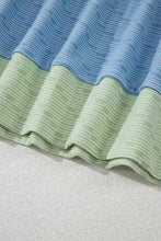 Close-up shot of Vivenza Luxe™ Contrast Top in light blue showing knit texture and contrast edging.