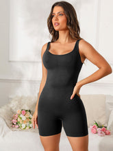 Model stretching pre-workout in black Vyvenca SculptFit Active Romper paired with trainers.