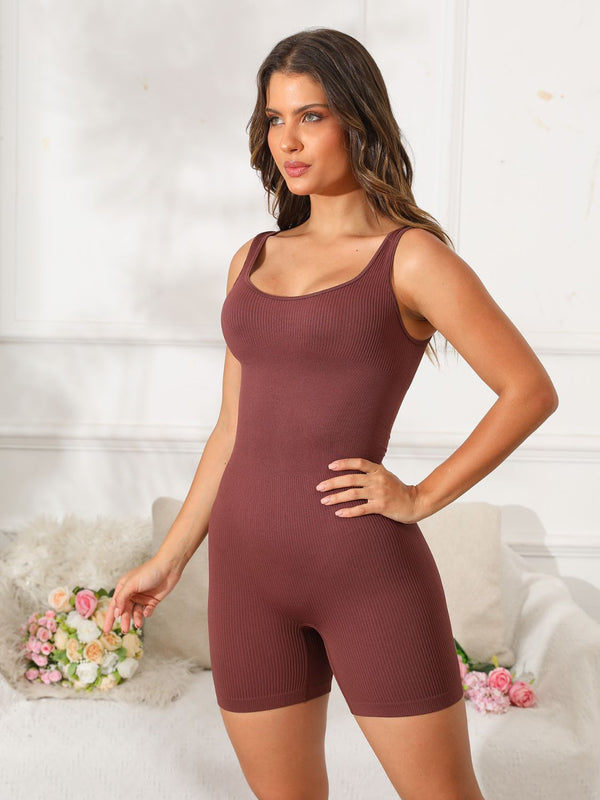 Model in dark brown Vyvenca SculptFit Active Romper, front view showing scoop neckline and curve-hugging fit.