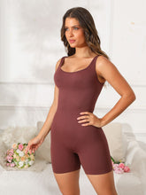 Model in dark brown Vyvenca SculptFit Active Romper, front view showing scoop neckline and curve-hugging fit.