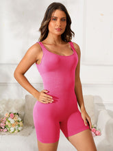 Model in strawberry Vyvenca SculptFit Active Romper, front view showing scoop neckline and curve-hugging fit.