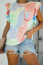  Side angle of the printed cap sleeve T-shirt in watermelon pink, styled with casual pants and sunglasses.