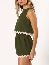 Model side view wearing an Army Green wavy mirage contrast trim short set with a white background.