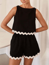 Woman showcasing the back of a Black Wavy Mirage Contrast Trim Shorts Set with a white background.