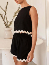 a model wearing the black wavy mirage contrast trim short set. 