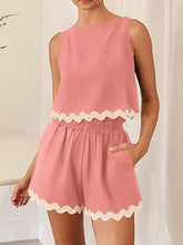 Model wearing a Coral wavy mirage contrast trim short set at a Spa.