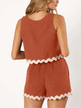 Woman showcasing the back of the Orange-Red Wavy Mirage Contrast Trim Shorts Set.