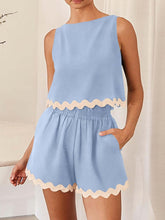 Model wearing a Pastel Blue wavy mirage contrast trim short set at a Spa.