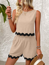 a woman modeling a Tan Wavy Mirage Contrast Trim Shorts Set at a mansion near a palm tree.