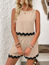 a woman modeling a Tan Wavy Mirage Contrast Trim Shorts Set at a masion