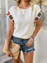 Model styled in white CrochetCharm Top with bootcut jeans and accessories for a complete look.