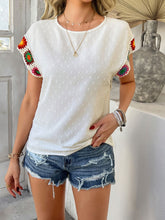 Model styled in white CrochetCharm Top with distressed jean shorts, sneakers, and accessories for a complete look.