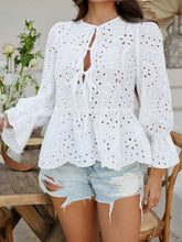 Casual street-style shot of model in PeplumMuse™ Blouse in White, styled with distressed jean shorts, brown straw handbag, layered necklaces, and neutral sneakers.