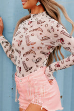Side view of model wearing a white Printed Mock Neck Long Sleeve Bodysuit with abstract print, paired with light denim jeans and minimal accessories.