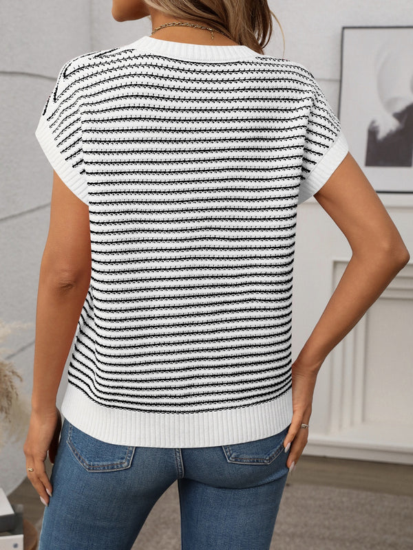 Back view of white striped knit top showing smooth fit and clean stripe alignment, worn with black trousers.