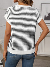 Back view of white striped knit top showing smooth fit and clean stripe alignment, worn with black trousers.