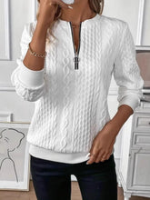 a woman modeling the white Sunset Coastal Bliss Texture Half Zip Long Sleeve Sweatshirt paired with jewelry, and dark blue denim jeans while taking a selfie photo at the studio