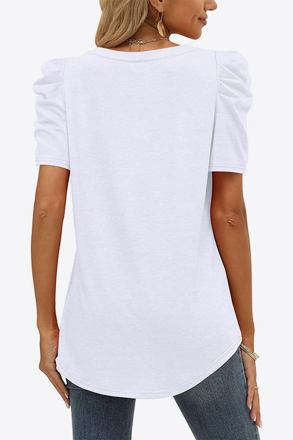 Back view of white V-neck puff sleeve tee showing smooth fabric and lightly gathered short sleeves.