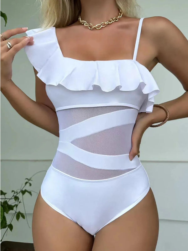 Close-up front view of white asymmetrical ruffled one-piece swimsuit showing sheer cutout and ruffled neckline