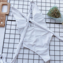 Back flat lay of white halter neck deep V tied one-piece swimsuit showing open back and tie straps