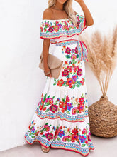 White Isadorae Dress styled with straw hat and tan clutch by the coast.