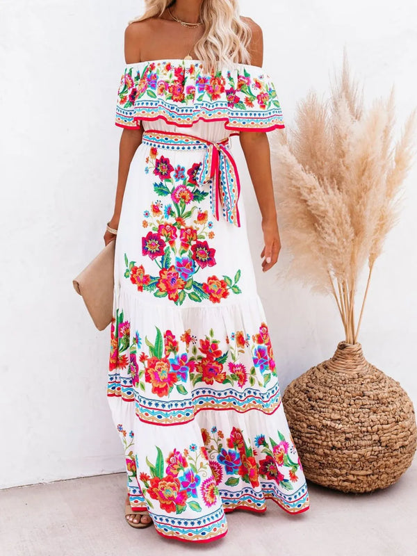 Model wearing white Isadorae Floral Off Shoulder Maxi Dress at a garden party.