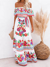 Model wearing white Isadorae Floral Off Shoulder Maxi Dress at a garden party.