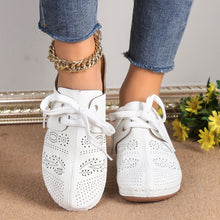 A model showcasing the front of a pair of the white Lace-Up Round Toe Wedge Sandals and a gold anklet and blue jeans.