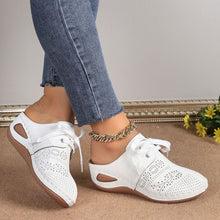 A model showcasing the sides of a pair of the white Lace-Up Round Toe Wedge Sandals and a gold anklet and blue jeans.