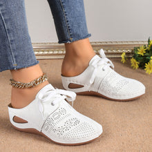 A model showcasing the sides of a pair of the white Lace-Up Round Toe Wedge Sandals and a gold anklet and blue jeans.