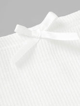 Close-up of White Rivéla Ruche Skirt front mini bow and ribbed texture
