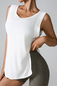 Woman modeling the front of the white Slit Round Neck Active Tank top highlighting the slit detail.